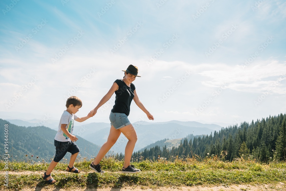 Young mom with baby boy travelling. Mother on hiking adventure with child, family trip in mountains. National Park. Hike with children. Active summer holidays. Young mom with baby boy travelling. Mother on hiking adventure with child, family trip in mountains. National Park. Hike with children. Active summer holidays.