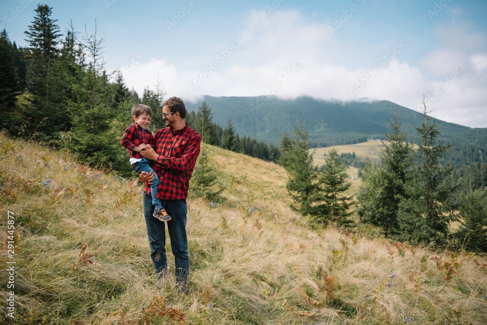 Young father with baby boy travelling. Father on hiking adventure with child, family trip in mountains. National Park. Hike with children. Active summer holidays.