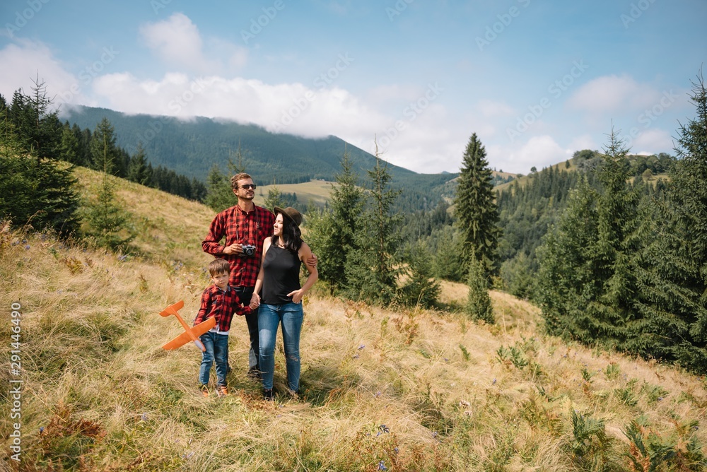 Young family with child resting on a mountain Young family with child resting on a mountain