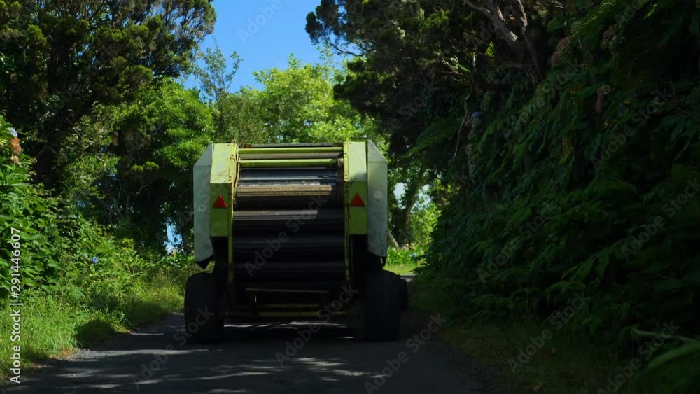 Following a Corn thresher tractor on the road. Green fields in Faial Island, Azores, Portugal Following a Corn thresher tractor on the road. Green fields in Faial Island, Azores, Portugal