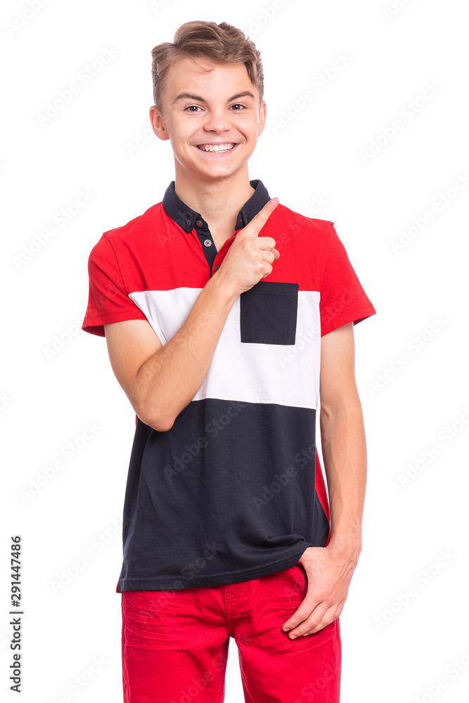 Portrait of happy teen boy pointing finger away at copy space, isolated on white background. Teenager pointing finger at something. Cute smiling child looking at camera. Portrait of happy teen boy pointing finger away at copy space, isolated on white background. Teenager pointing finger at something. Cute smiling child looking at camera.