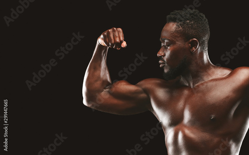 Cropped image of black guy showing his great biceps