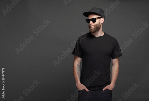Hipster handsome male model with beard wearing black blank t-shirt with space for your logo or design © 4Max