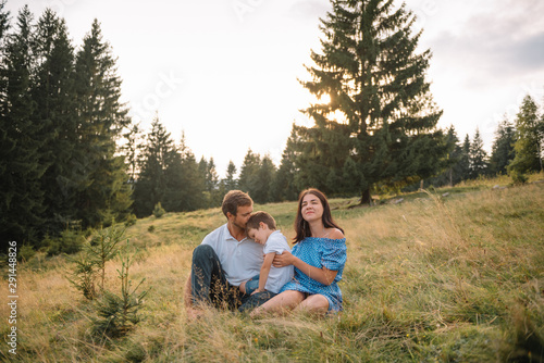 Young family with child resting on a mountain. vacation in the national park © Serhii