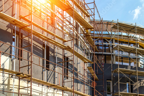 Wallpaper Mural Extensive scaffolding providing platforms for work in progress on a new apartment block,Tall building under construction with scaffolds,Construction Site of New Building Torontodigital.ca