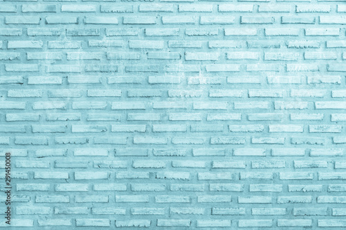 Brick wall painted with pale blue paint pastel calm tone texture background. Brickwork and stonework flooring interior rock old pattern clean concrete grid uneven bricks design.