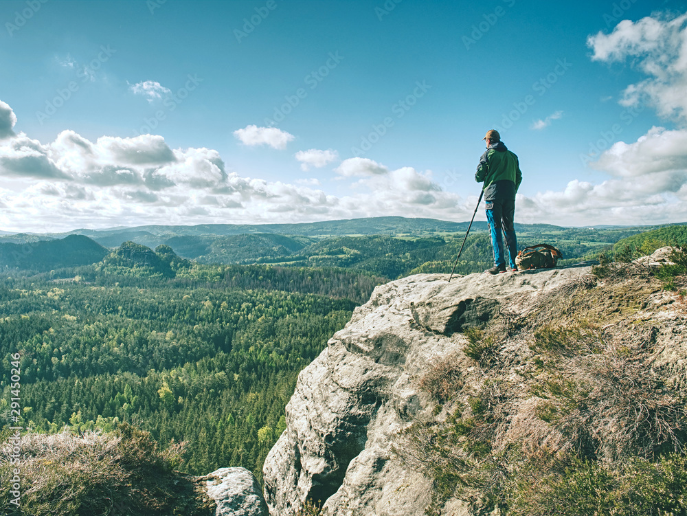 Man photographer taking picture of landscape when set tripod