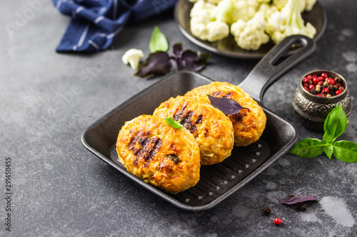 Baked cabbage rissoles in cast iron skillet. Selective focus, copy space.