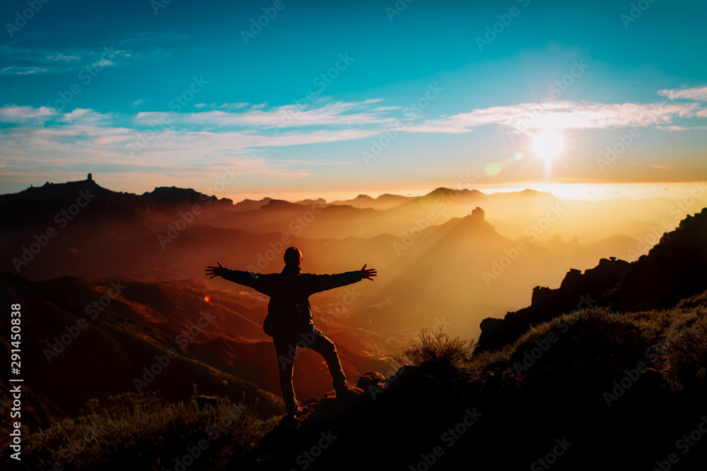 happy tourist enjoy hiking in sunset mountains