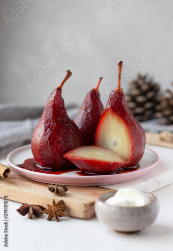 Red wine poached pears in white plate and mascarpone cheese, delicious winter french dessert, copy space