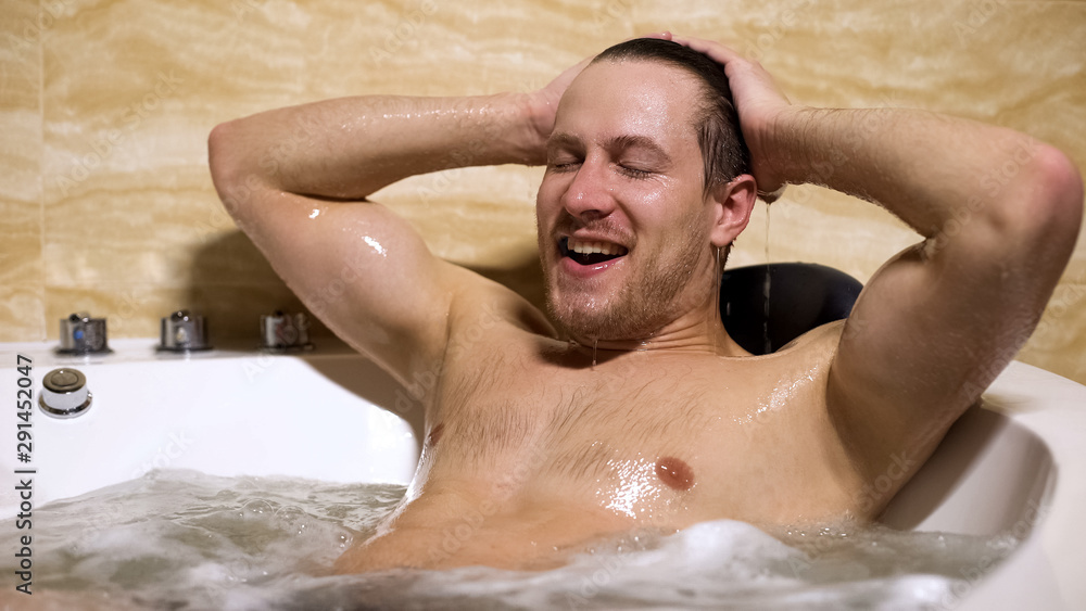 Handsome man enjoying bathing, satisfied with pleasure home spa procedures Handsome man enjoying bathing, satisfied with pleasure home spa procedures