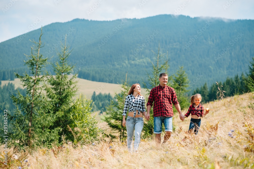 Young family with child resting on a mountain Young family with child resting on a mountain