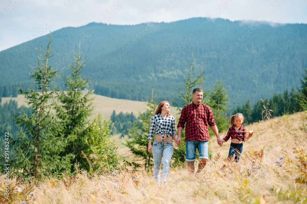 Young family with child resting on a mountain