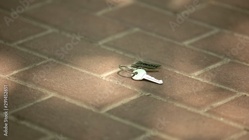 Lost keys from home lying on floor, carelessness and inattentiveness concept photo