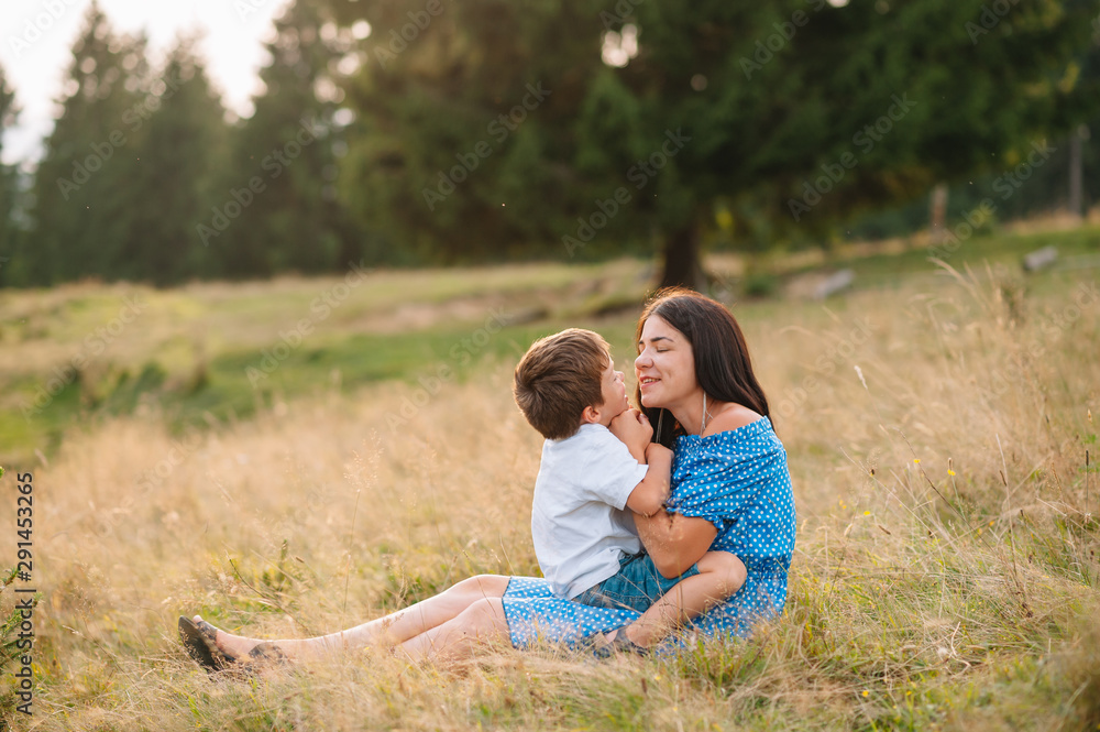 mother and son having rest on vacation in mountains. Young family with child resting on a mountain. vacation in the national park mother and son having rest on vacation in mountains. Young family with child resting on a mountain. vacation in the national park