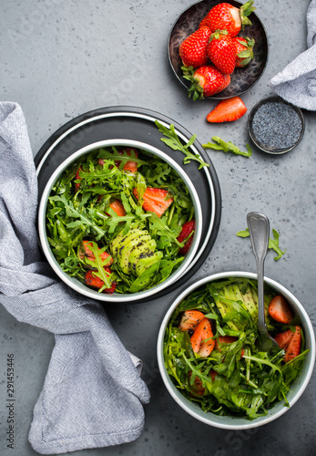 Green salad with strawberries, arugula and avocado