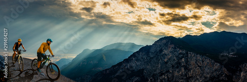 Cycling man riding on bike at sunrise mountains and Garda lake landscape. Cycling MTB enduro flow sentiero ponale trail track. Outdoor sport activity.