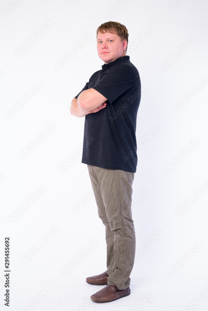 Fototapeta premium Full body shot profile view of overweight man looking at camera