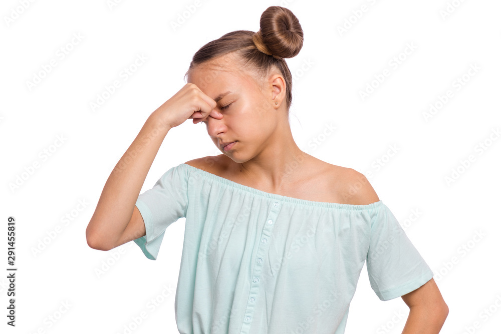 Portrait of teen girl touching her head suffering headache looking tired and sad. Unhappy beautiful caucasian young teenager suffering from headache, isolated on white background. Portrait of teen girl touching her head suffering headache looking tired and sad. Unhappy beautiful caucasian young teenager suffering from headache, isolated on white background.