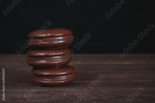 Chocolate chip cookies on a dark wooden table. Background image. Tasty breakfast.