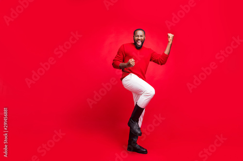 Full length body size view of his he nice attractive cheerful cheery content overjoyed satisfied bearded guy having fun rejoicing isolated over bright vivid shine red background © deagreez
