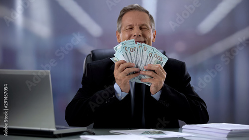Valokuva Happy businessman hugging bunch of dollars, successful start up, contract