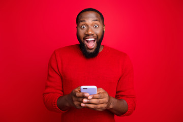 Close-up portrait of his he nice attractive cheerful cheery excited glad bearded guy using wireless connection wi-fi app 5g blog post smm fast speed isolated over bright vivid shine red background
