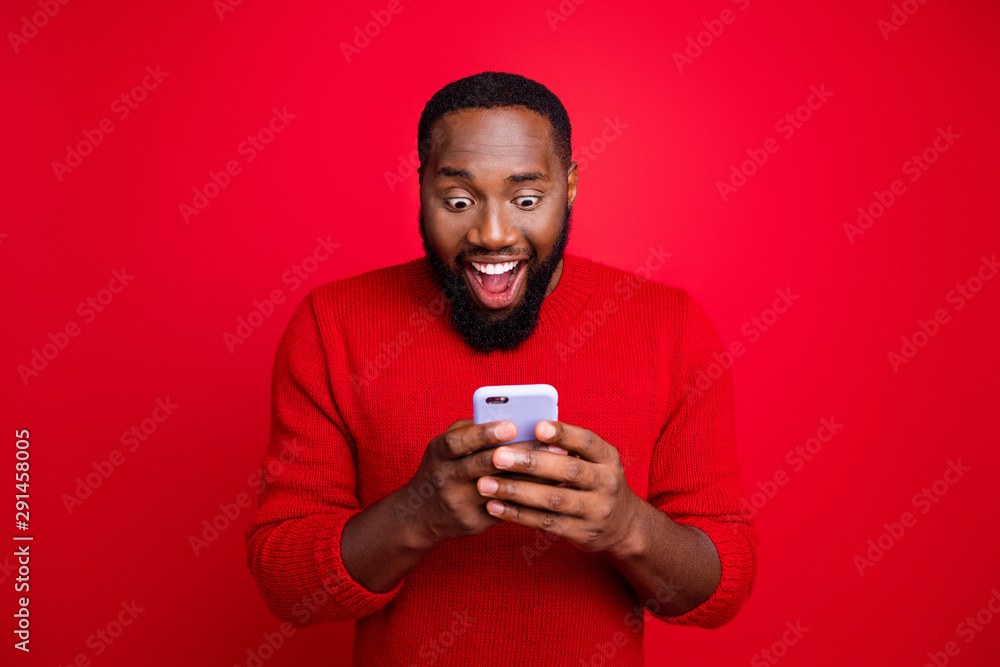 Close-up portrait of his he nice attractive focused cheerful cheery glad excited bearded guy using wireless connection app 5g blog post smm like isolated over bright vivid shine red background Close-up portrait of his he nice attractive focused cheerful cheery glad excited bearded guy using wireless connection app 5g blog post smm like isolated over bright vivid shine red background