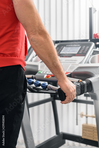 Closeup photo of man running on treadmill during cardio test