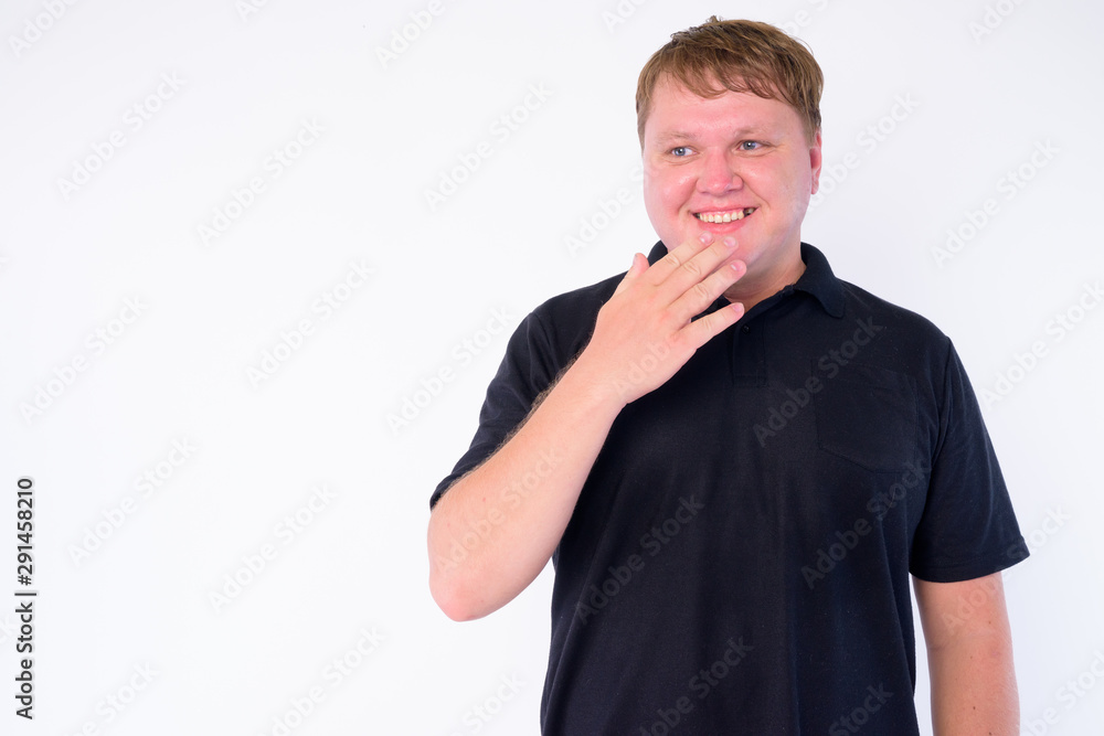 Portrait of happy overweight man covering mouth while laughing Portrait of happy overweight man covering mouth while laughing