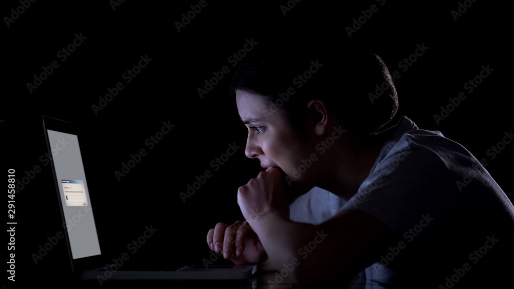 Nervous woman waiting for files downloading or upgrading of software on laptop Nervous woman waiting for files downloading or upgrading of software on laptop