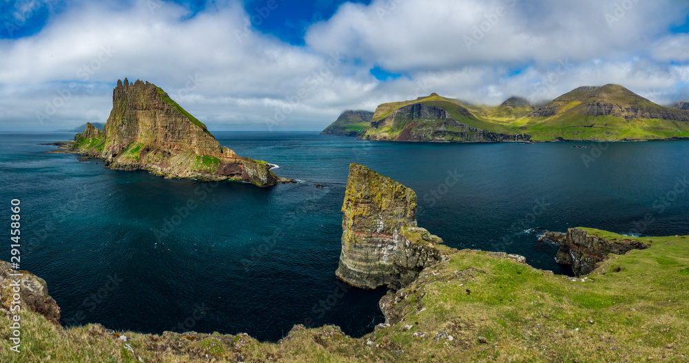 Fototapeta premium Amazing panorama with Tindholmur vertical cliff and coastline, Faroe Islands