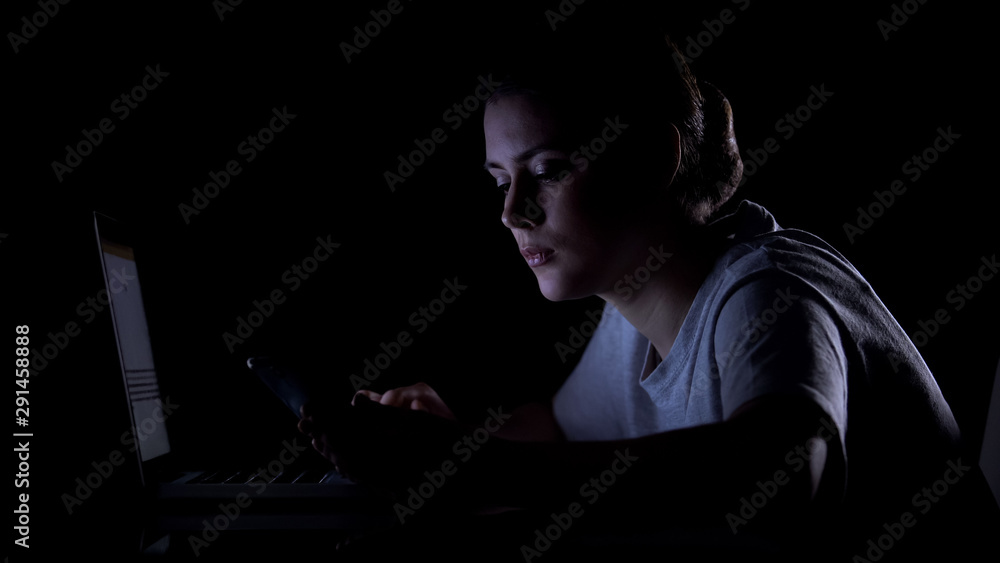 Lonely girl checking in on dating web site, confirming password on smartphone Lonely girl checking in on dating web site, confirming password on smartphone