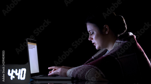 Photography Crying female freelancer working on laptop at night, hard labor conditions