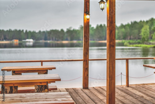 View from an outdoor cafe on the background of a forest lake
