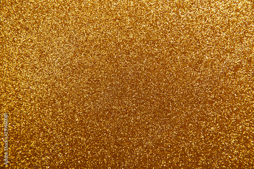 Gold glittering christmas lights. Blurred abstract background.