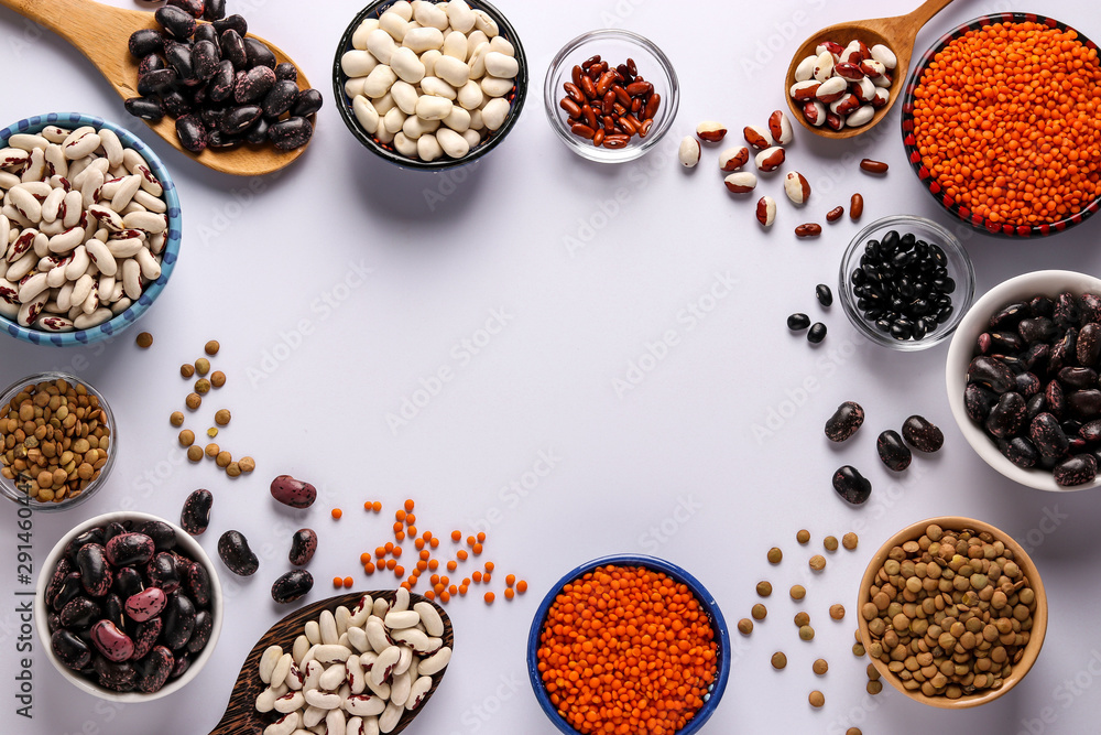 Red and brown lentils, black, brown and white beans are legumes that contain a lot of protein are located in bowls on white background, horizontal orientation, copy space