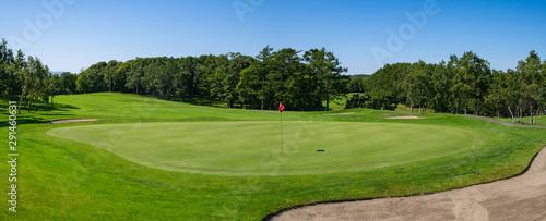 Panorama View of Golf Course with beautiful putting green. Golf course with a rich green turf beautiful scenery. photo