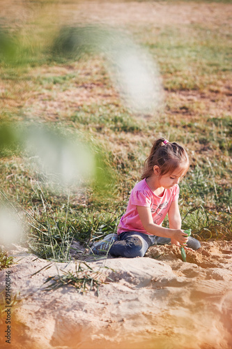 Little girl playing in sandbox