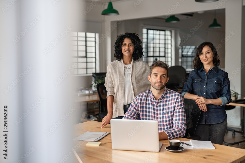 Diverse group of smiling designers working together in an office Diverse group of smiling designers working together in an office