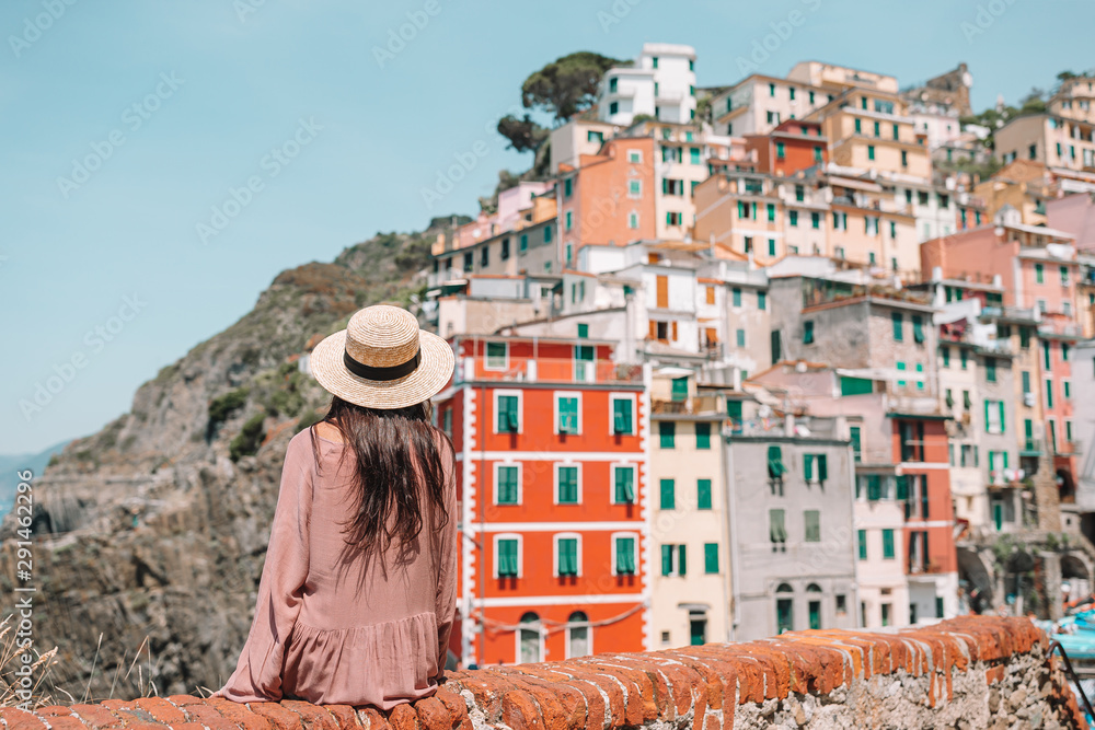 Young woman with great view at old village Riomaggiore, Cinque Terre, Liguria