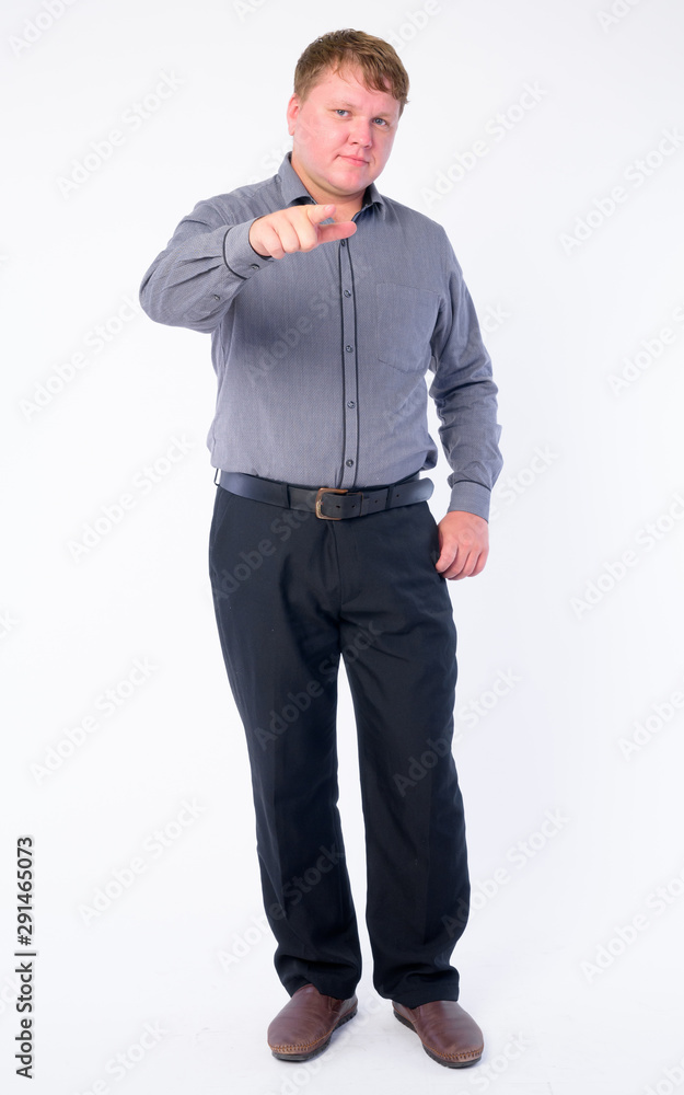 Full body shot of overweight businessman pointing at camera Full body shot of overweight businessman pointing at camera