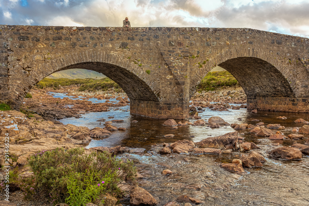 Woman on a bridge in Scotland.