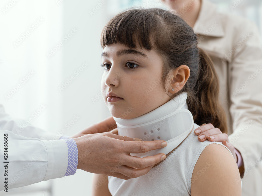 Doctor visiting a young girl with cervical collar
