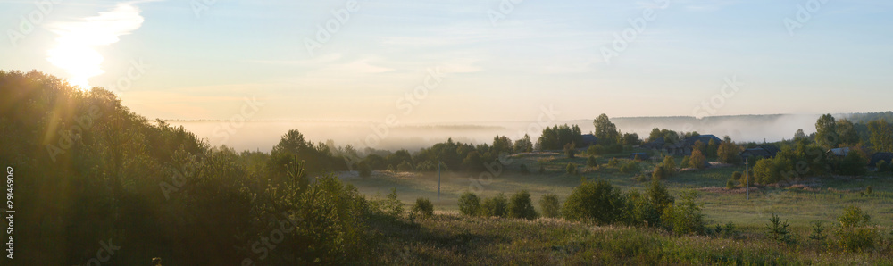 Beautiful panorama of a rural place with dawn and fog