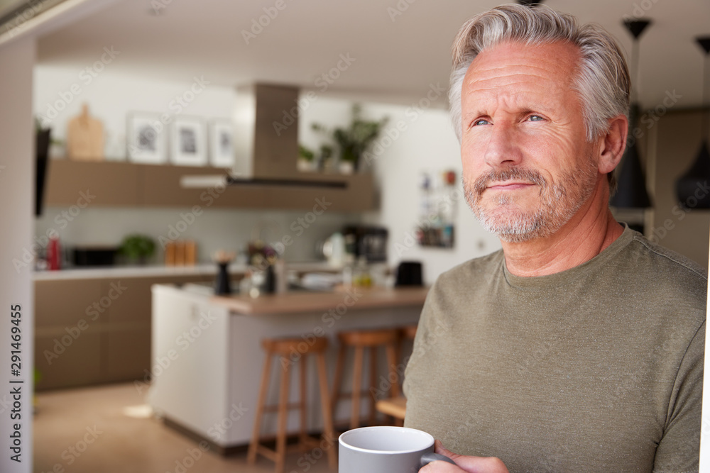Senior Man Standing And Looking Out Of Kitchen Door Drinking Coffee Senior Man Standing And Looking Out Of Kitchen Door Drinking Coffee