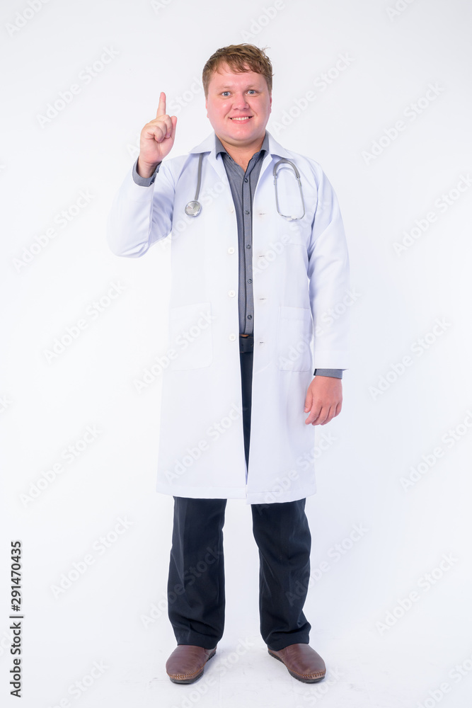 Full body shot of happy overweight man doctor pointing up Full body shot of happy overweight man doctor pointing up