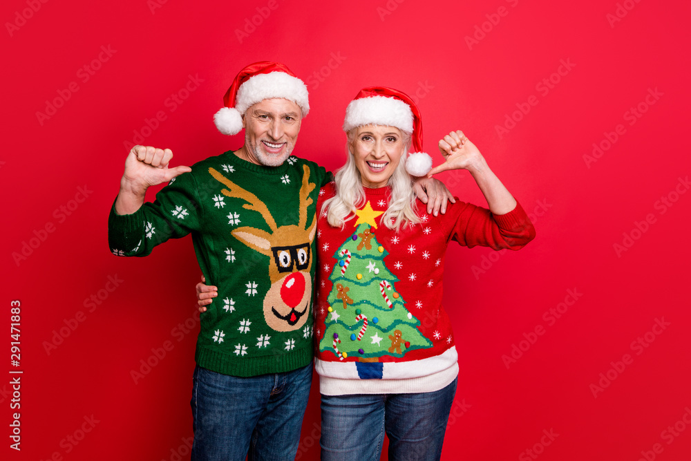 Just look at us. Photo of two crazy cheerful delightful confident grey white haired husband wife pointing at themselves showing funky jumpers isolated vivid color background Just look at us. Photo of two crazy cheerful delightful confident grey white haired husband wife pointing at themselves showing funky jumpers isolated vivid color background