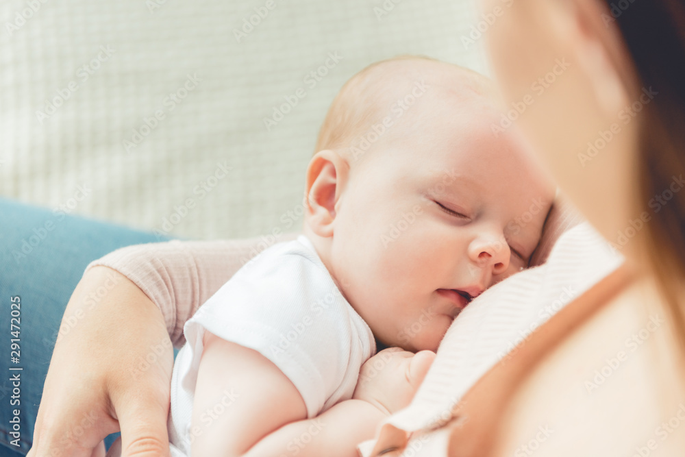 cropped view of mother holding her sleeping child in apartment cropped view of mother holding her sleeping child in apartment
