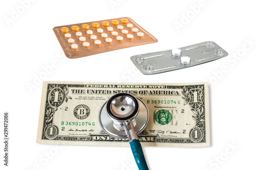 Stethoscope on Bank note one dollar money and birth control pill and contraceptive pill ,or morning after pill isolated on white, image for abortion concept. photo